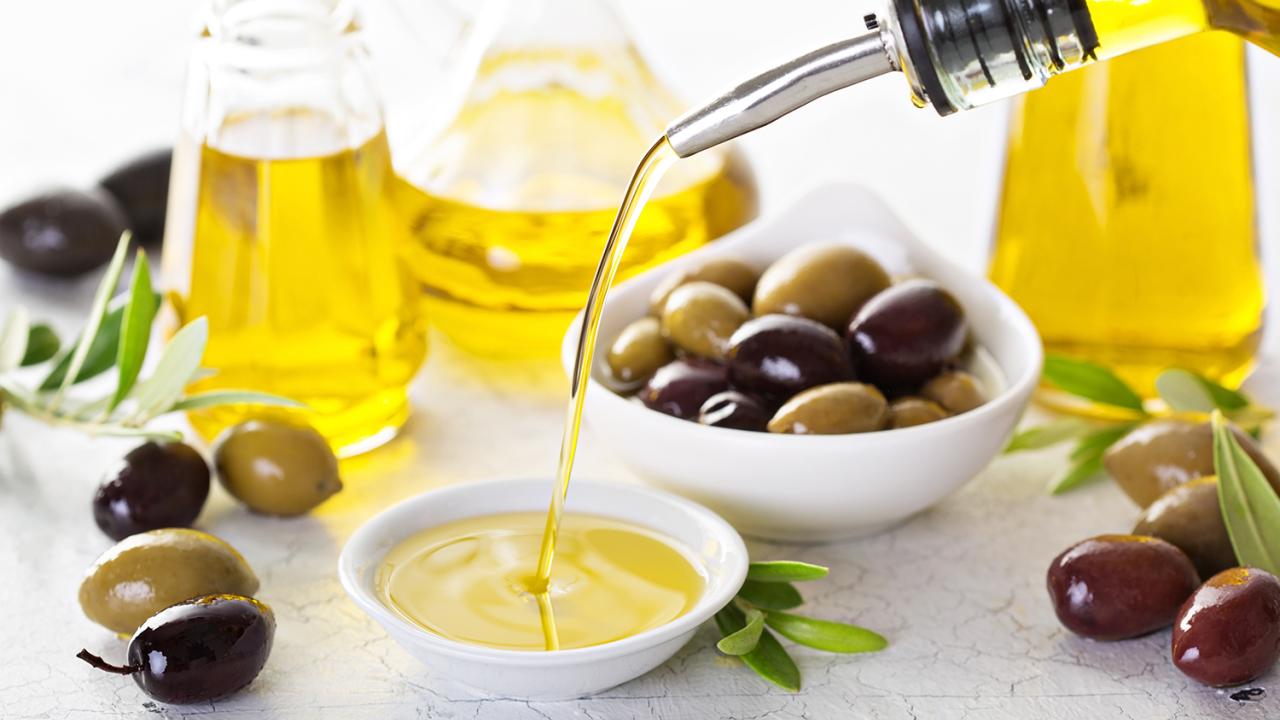 Olive oil pouring from bottle
