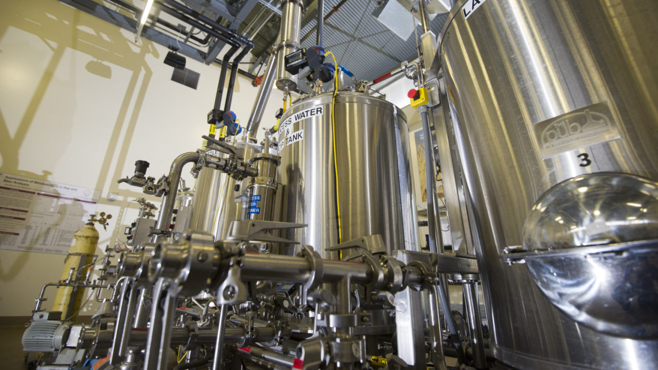 Industrial equipment with stainless steel tanks and pipes in the UC Davis Brewery