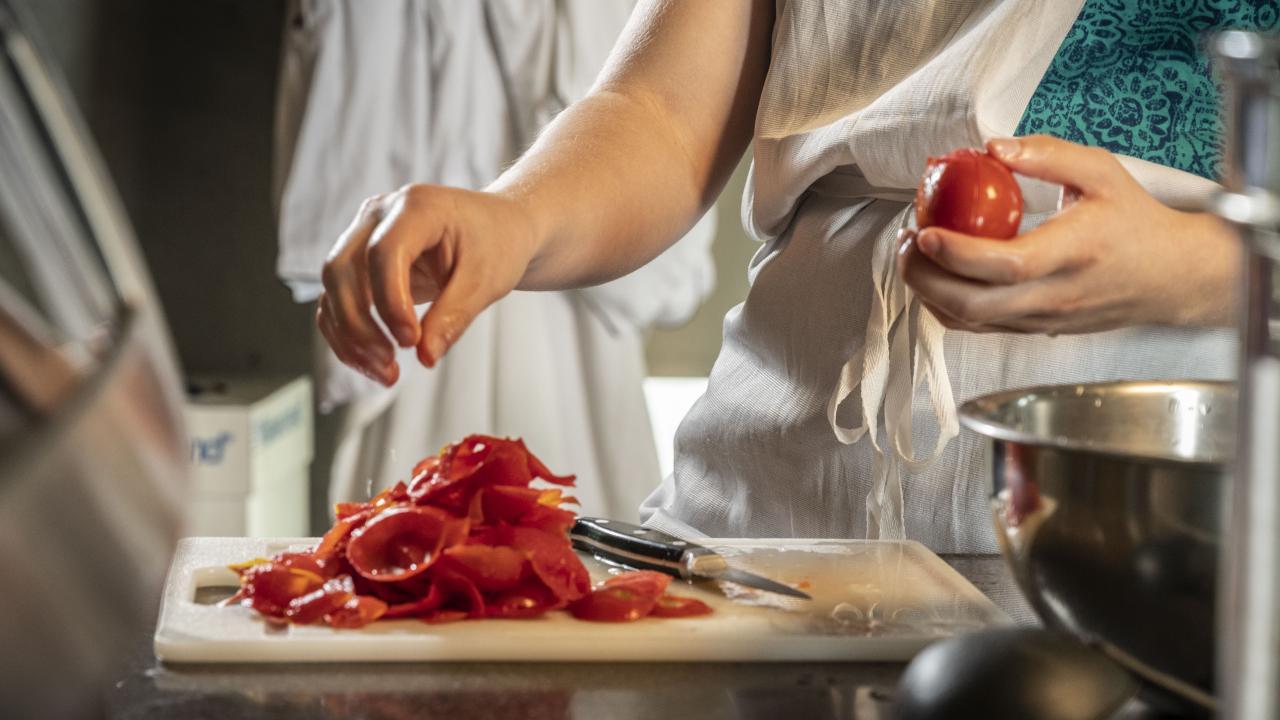 Hands preparing tomatoes to make canned tomato sauce. Established with support from the Trinchero family, the Darrell Corti Endowed Professor in Food, Wine and Culture will explore the cultural significance of food and wine while offering students more unique learning opportunities.