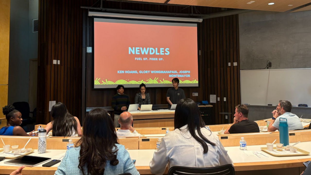 Students presenting in front of guests