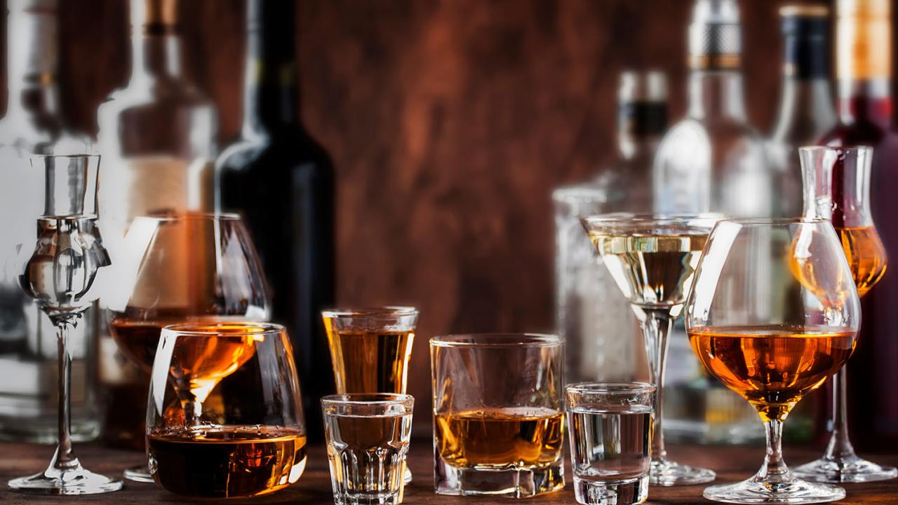 variety of spirits in bottles and glasses