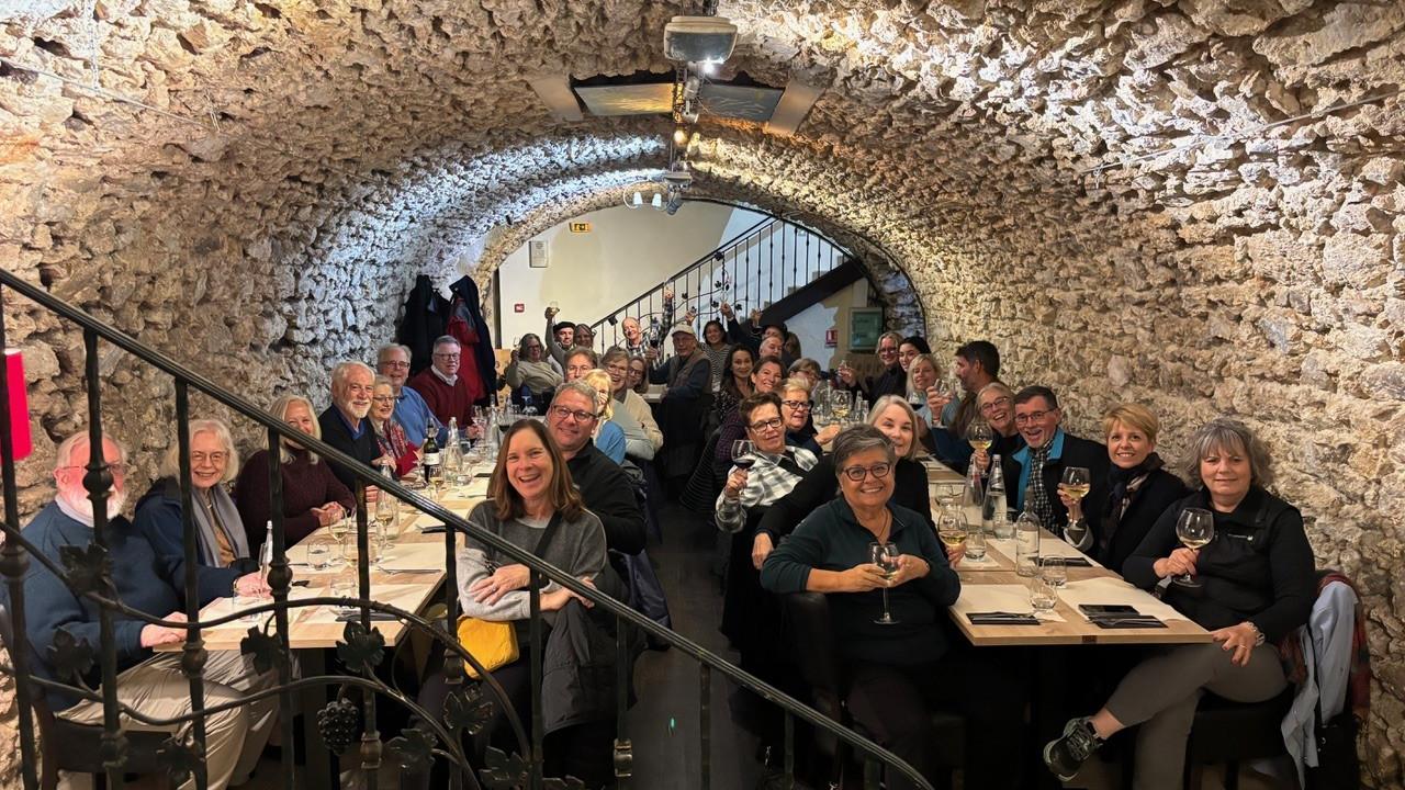 CAAA French wine trip attendees at dinner in a cave 2024