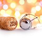 Wine cork with 2024 printed on it with lights in the background