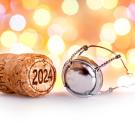 Wine cork with 2024 printed on it with lights in the background