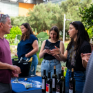 Students pouring wine for guests