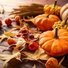 Pumpkins and fall leaves on a wooden table