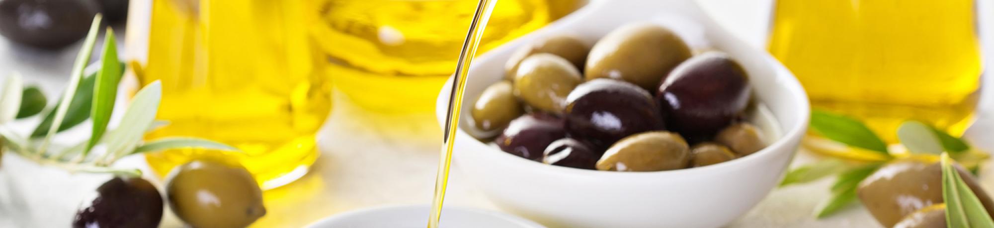Olive oil pouring from bottle